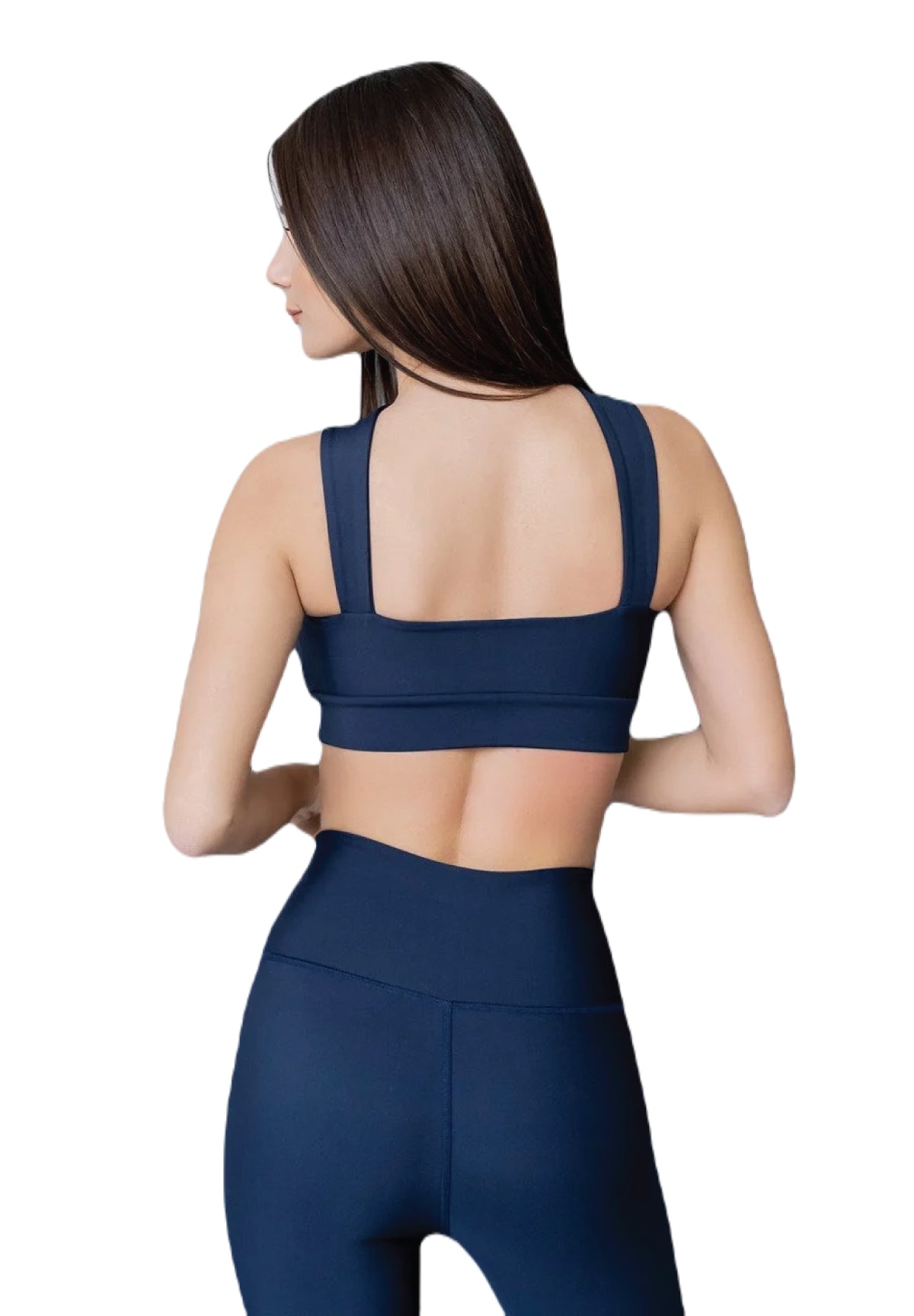 Eine Frau in marineblauen Lismina 296 Extra High Waist Leggings, von hinten gesehen, mit langen braunen Haaren, schaut zur Seite.